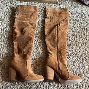 Brown suede, lace up knee high boots.